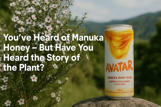 Manuka bush in bloom with delicate white-pink flowers, paired with a can of Avatar Elixir and styled to highlight the plant’s connection to New Zealand’s iconic honey.