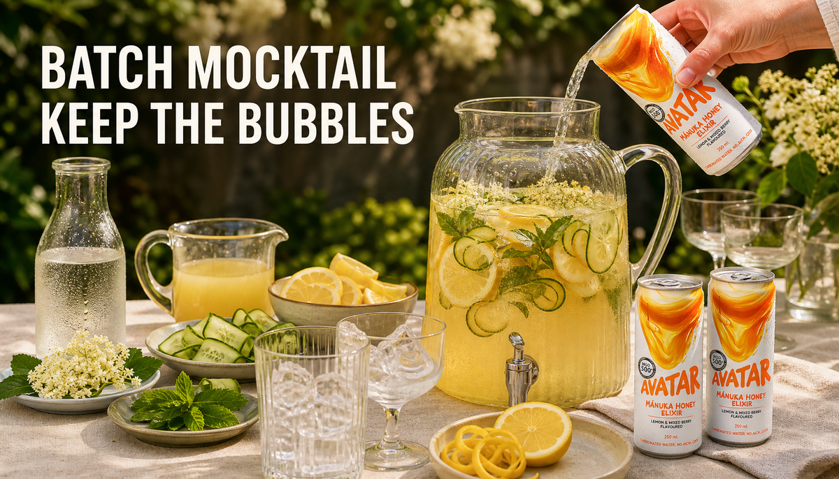 Garden brunch batch mocktail setup with Avatar Elixir, a glass pitcher of honey lemon elderflower drink, citrus garnish, chilled cans, and serving glasses with ice.