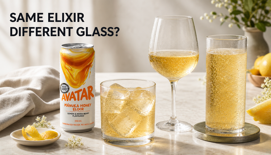 Avatar Elixir can beside a tumbler, wine glass, and highball filled with the same sparkling honey drink for a glassware tasting experiment.