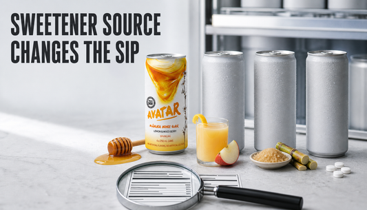 Editorial hero image comparing natural energy drink sweeteners, with an Avatar Manuka honey drink beside generic cans, honey, fruit juice, cane sugar, sweetener tablets, and a nut...