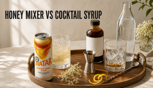 Editorial home bar comparison of an opened Avatar Elixir honey mixer can beside a glass of ice and a generic cocktail syrup setup with jigger, spoon, and sparkling water, with hea...