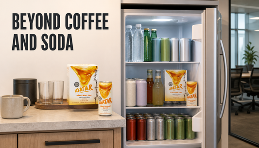 Open office drinks fridge stocked beyond coffee and soda with sparkling water, tea, mixers, and Avatar Manuka honey drinks for a workplace meeting room.