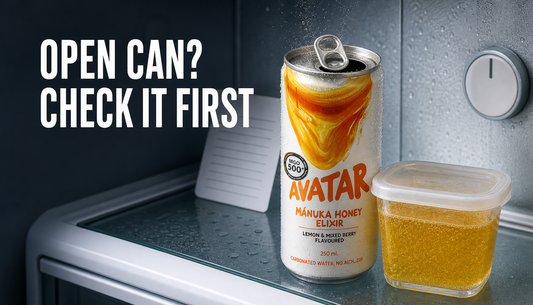 An opened Avatar Elixir can sits in a refrigerator beside a small sealed container, with fizz escaping from the can and headline text reading OPEN CAN? CHECK IT FIRST.