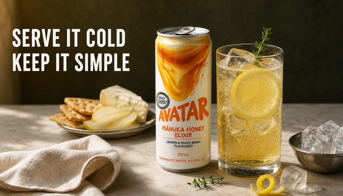Avatar Elixir can beside a chilled glass of pale golden honey energy drink with ice, lemon, herb garnish, and simple snack pairings.