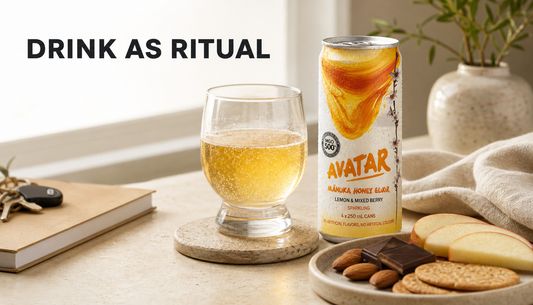 The Founders’ Reserve natural energy drink served in a glass with a small food pairing on a calm tabletop ritual setting.