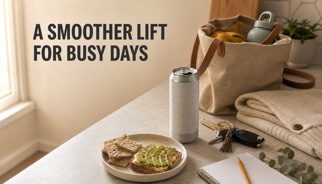 Late-afternoon kitchen counter with a generic natural energy drink can, snack, keys, tote bag, and the headline A SMOOTHER LIFT FOR BUSY DAYS.