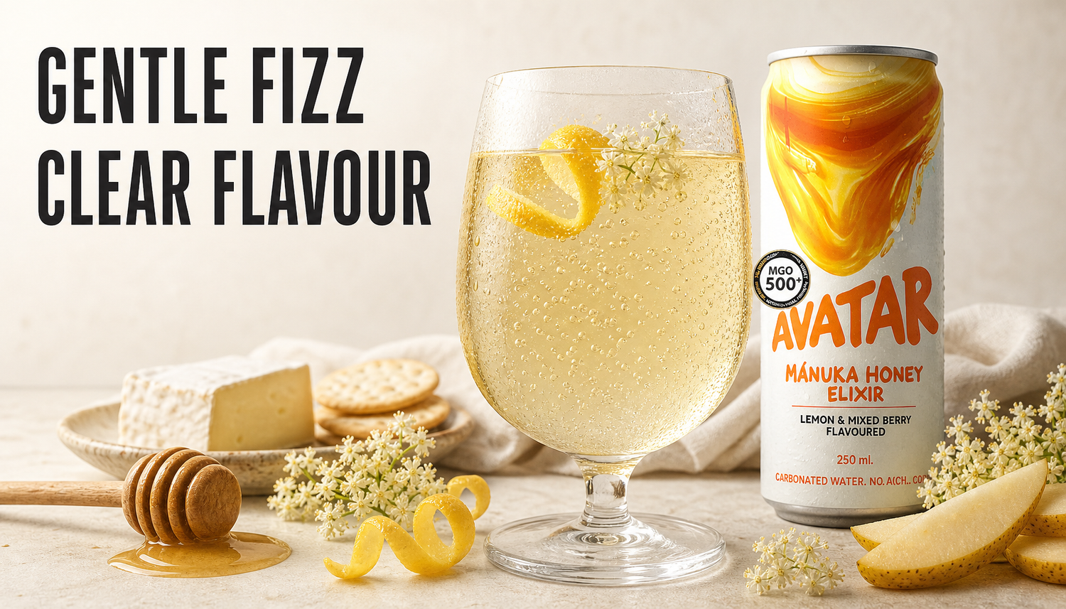 Avatar Elixir can beside a chilled glass with fine gentle bubbles rising through a pale honey drink, with lemon, elderflower, honey, cheese, crackers, and fruit on a warm stone ta...
