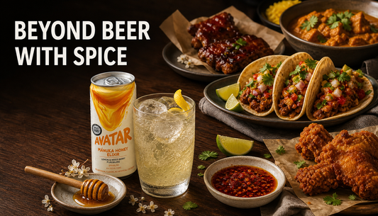 Spicy tacos, curry, fried chicken, chilli oil, and a chilled sparkling honey lemon drink with Avatar Elixir on a warm dinner table under the headline Beyond Beer With Spice.