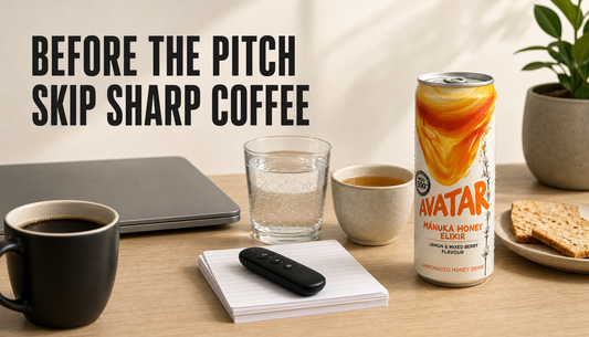 Editorial hero showing coffee pushed aside before a presentation, with water, tea, a light snack, speaking notes, and Avatar Elixir arranged as calmer drink options.