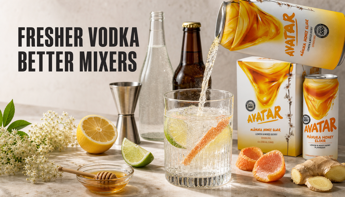 Editorial home-bar scene showing a sparkling citrus mixer being poured into a measured vodka glass, surrounded by citrus, honey, elderflower, bubbles, and Avatar Manuka honey drin...