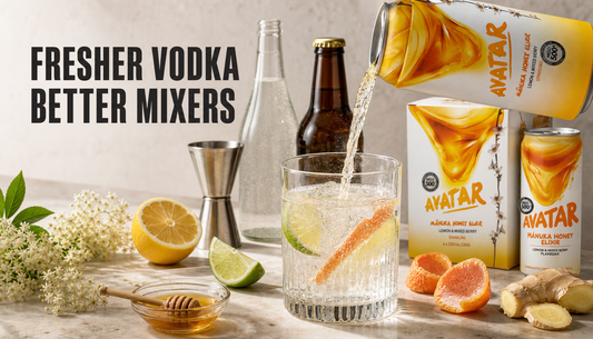 Editorial home-bar scene showing a sparkling citrus mixer being poured into a measured vodka glass, surrounded by citrus, honey, elderflower, bubbles, and Avatar Manuka honey drin...