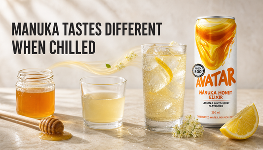 Avatar Elixir beside a chilled sparkling glass, lemon, elderflower, honey water, and an ordinary honey spoon, showing how Manuka honey tastes different when served cold.